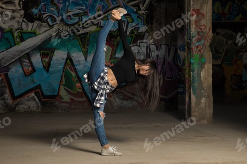 Preview: Full Length Portrait Of A Female Urban Dancer Doing A Leg Split While Performing In An Abandoned