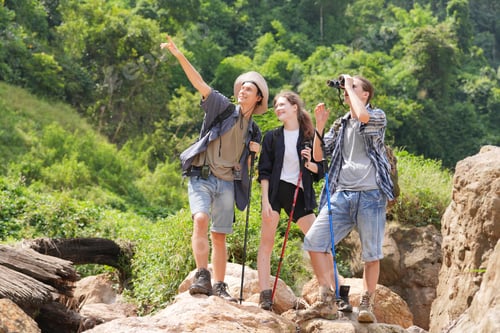 Preview: Hikers walking along a trail on a mountain with hiking sticks