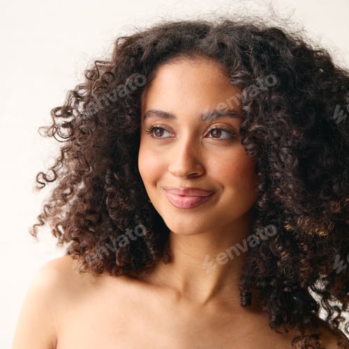Preview: Studio Portrait Of Smiling Natural Woman With Bare Shoulders Standing Against Neutral Background