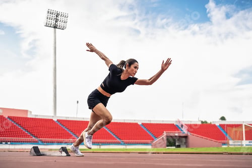 Preview: Asian young sportswoman sprint on a running track outdoors on stadium.