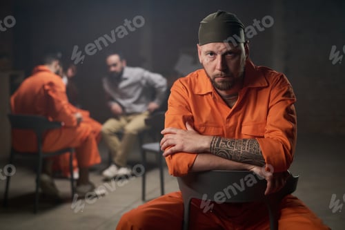 Preview: Caucasian Man Sitting in Group Therapy Session in Prison Setting