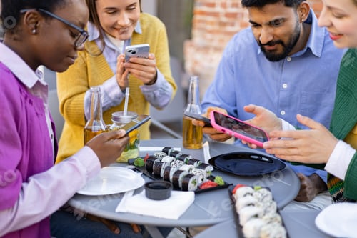 Preview: Friends Sharing Sushi and Phones