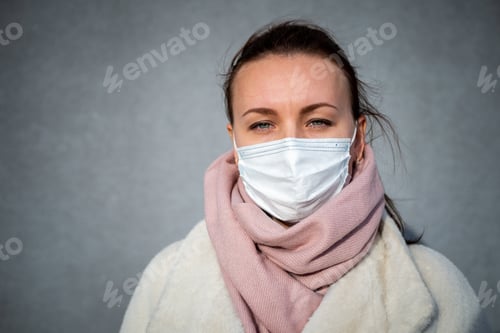 Preview: A picture of a girl in a mask. On the street. isolated Covid-19 pandemic.