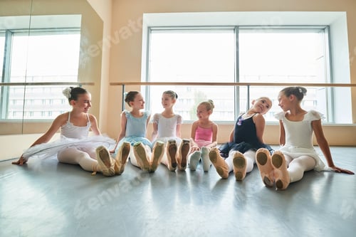 Preview: Happy young ballerinas sitting on the floor