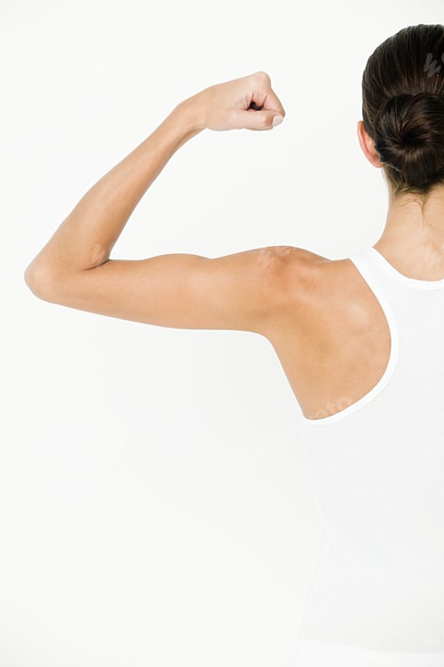 Preview: Young woman flexing muscles