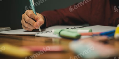 Preview: Low angle closeup view of a child making homework
