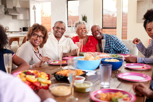 Preview: Grandfather making a toast standing at the dinner table celebrating with his family,close up