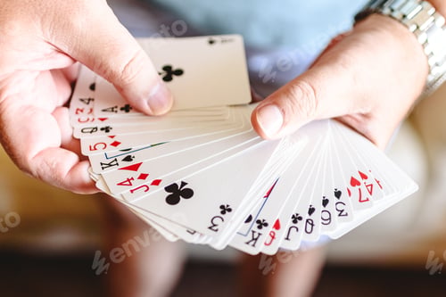 Preview: Magician hands doing magic trick with playing cards.