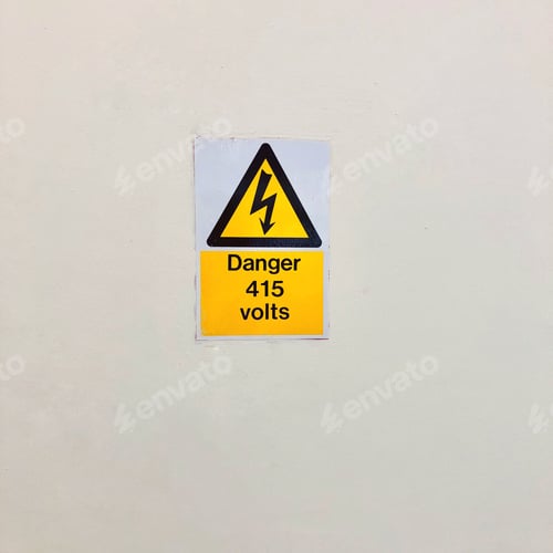 Preview: Yellow danger sign 415 volts On a white wall