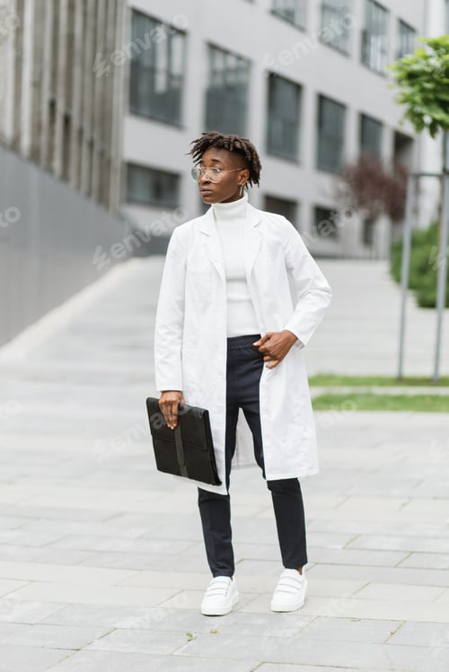 Preview: Portrait of young smart focused african female medical intern doctor with folder clipboard