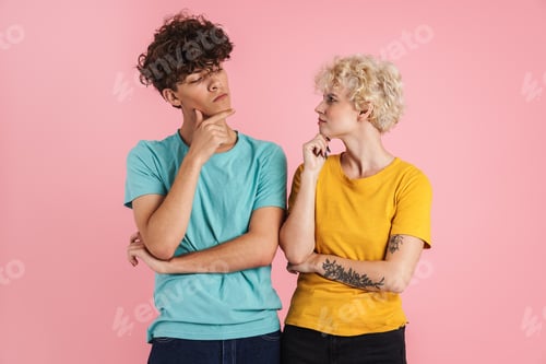Preview: Portrait of a pensive teenage couple standing isolated