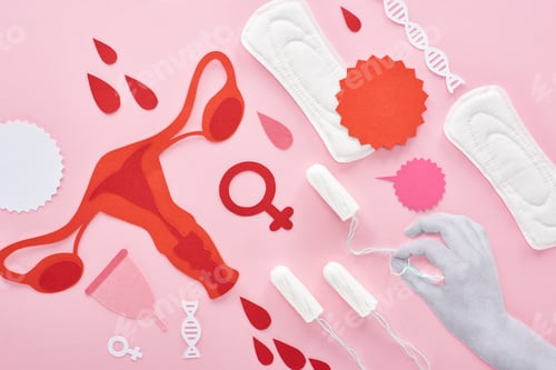 Preview: cropped view of white hand holding tampon on pink background with sanitary napkins, paper cut female
