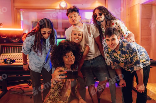 Preview: Multiracial music band taking a photo of them self after recording a new song