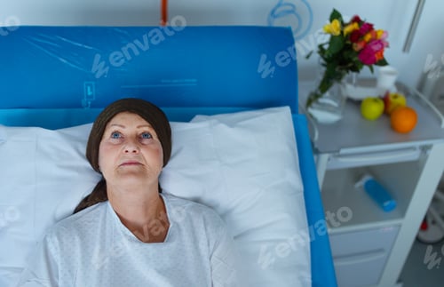 Preview: Senior woman lying in hospital room after chemotherapy.