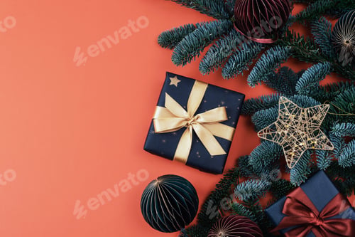 Preview: Christmas gift, baubles and fir branches on red background. Top view, flat lay, copy space