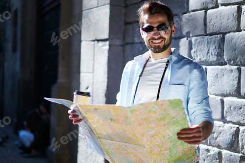 Preview: Happy man with map and coffee to go
