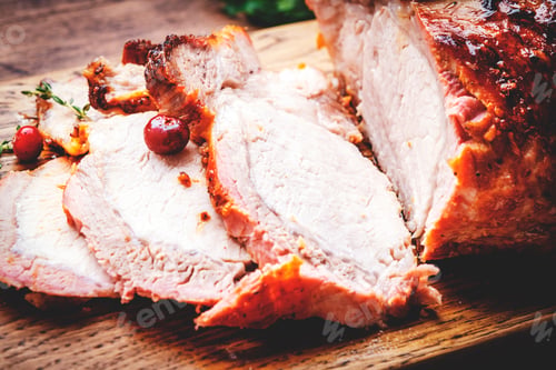 Preview: Baked festive pork butt or ham with herbs, spices and cranberries for sauce, served and sliced