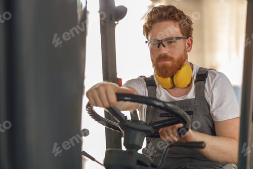 Preview: Professional forklift driver in working in wood warehouse and loading wooden board