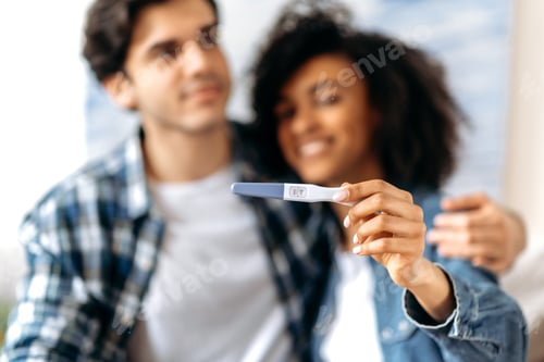 Preview: Joyful blurred young mixed married couple enjoying the good news, getting ready to become parents
