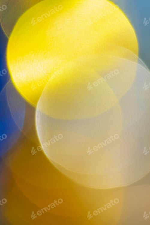 Preview: Defocused abstract blurry bokeh background yellow color. Festive Christmas lens flare effect