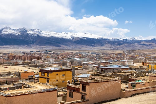 Preview: Elevated cityscape view of Litang old town in Ganzi Tibetan autonomous region, with scenic mountains