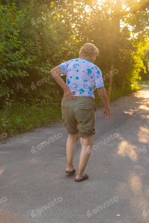 Preview: Old woman has back pain. Selective focus.