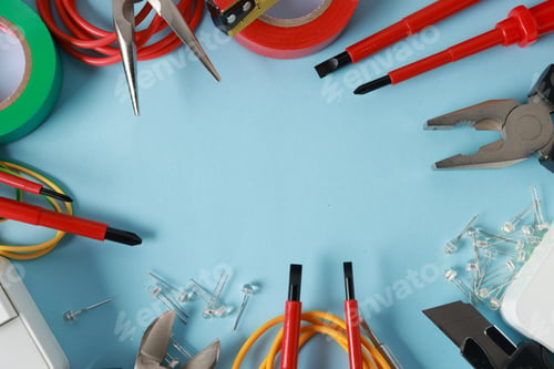 Preview: Frame of different electrical tools on light blue background, flat lay. Space for text