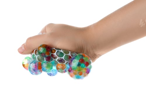 Preview: Woman squeezing colorful slime isolated on white, closeup. Antistress toy