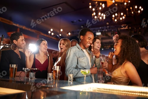 Preview: Group Of Couples With Friends Drinking In Bar Together
