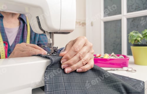 Preview: Seamstress hands working on a sewing machine