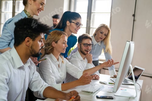 Preview: Group of business people and software developers working as a team in office