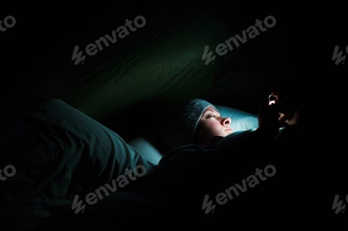 Preview: Woman lying in a tent at night, illuminated by a torch.