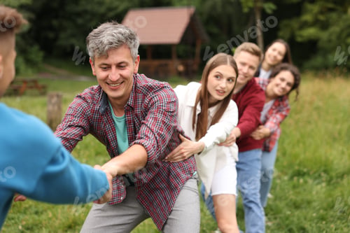 Preview: Team building. Group of happy people holding hands outdoors