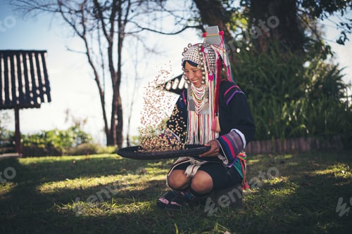 Preview: Akha in the north of Thailand enjoying coffee from shell by bamboo basket with traditional cloth.