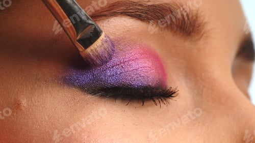 Preview: Make-up artist applies makeup to the upper eyelid, close-up. Makeup artist applies a bright shadow
