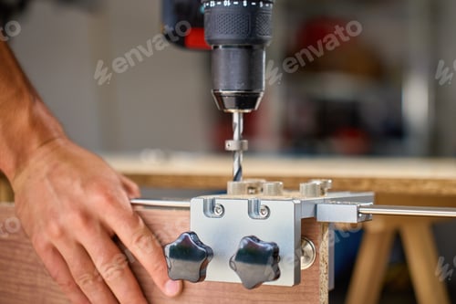 Preview: Carpenter drilling wooden panel using jig tool for precise holes