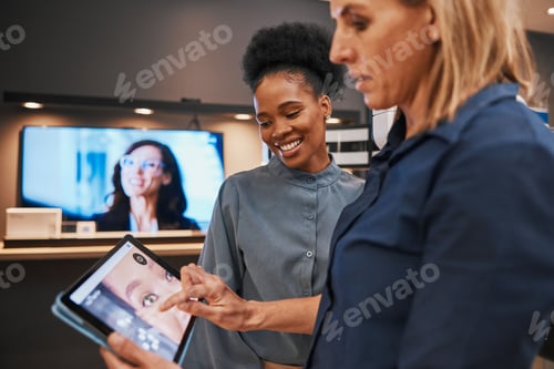 Preview: Digital tablet, creative and employees in the office editing advertisement images together. Collabo