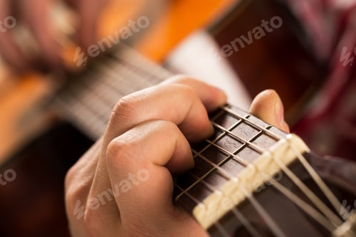 Preview: Music, close-up. Musician holding a wooden guitar