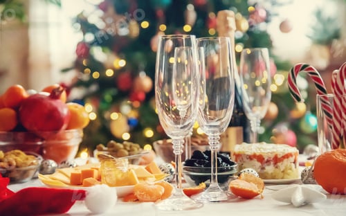 Preview: Christmas table with champagne and food. Selective focus.