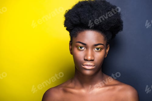 Preview: Front view of beautiful african american looking at camera on black and yellow