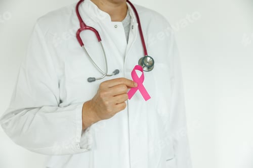 Preview: Doctor woman with pink ribbon on her chest, supporting symbol of breast cancer awareness