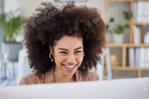 Preview: Closeup portrait of one young smiling African American woman using a desktop while sitting at a des