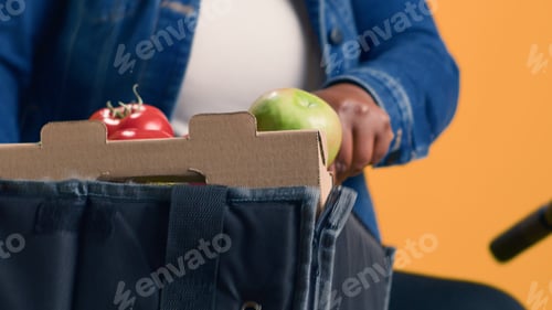 Preview: Woman holding box of fresh produce