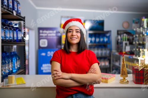 Preview: Young woman smiling with arms crossed, celebrating christmas in an auto parts store