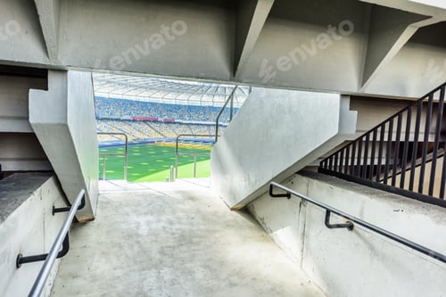 Preview: rows of yellow and blue stadium seats on soccer field stadium