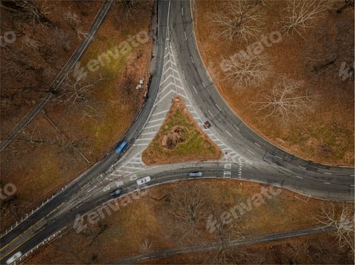 Preview: Top down view over an intersection, in a triangular shape, on a cloudy day in autumn.