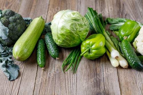 Preview: Green raw vegetables on wooden background. Healthy organic food.