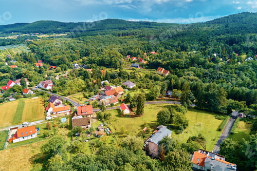 Preview: Village in mountains with forest, aerial view. Mountain landscape