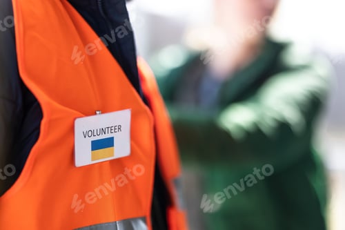 Preview: Volunteer registring Ukrainian refugees at train station, close-up