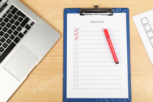 Preview: Checklist with checkboxes, marker and laptop on wooden table, flat lay